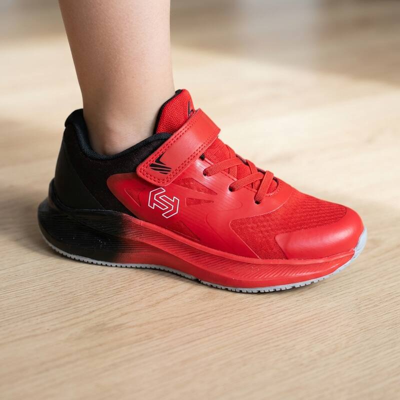 Red/Black Lastwell sneaker on a child's foot